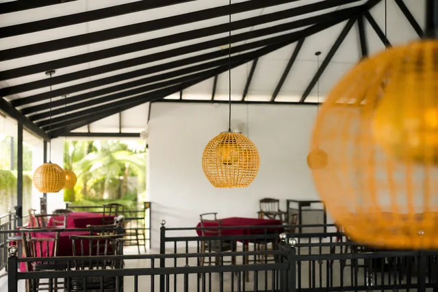 Woven pendant lampshades above the dining tables at Tèya Beach Restaurant