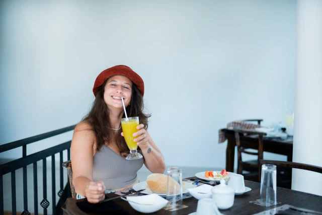 Guest enjoying fresh juice at breakfast on the hotel terrace
